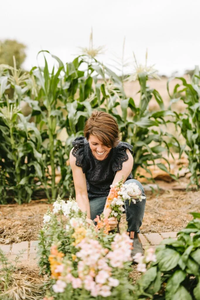 Artist Emma Fuss in her flower garden.