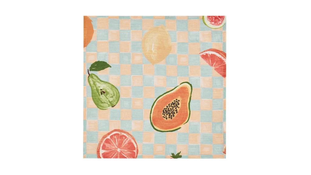 A linen napkin with a checker pattern and illustrations of fruit on it