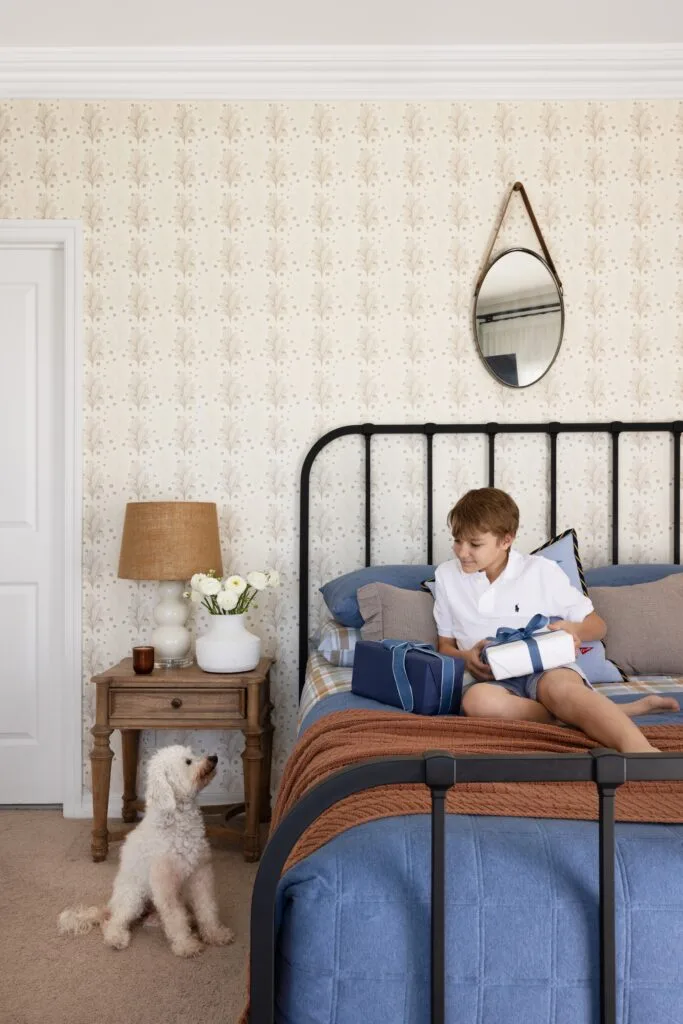 A classic neutral coloured kid's bedroom with son Orly and Holly the spoodle.