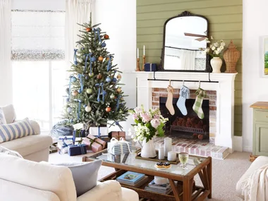 A classic living area with green accents and a Christmas tree.
