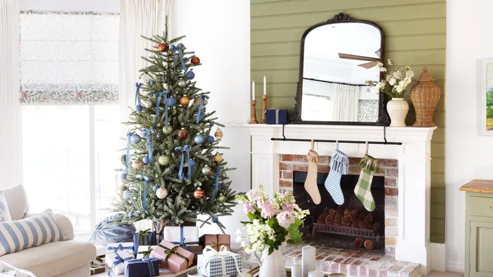A classic living area with green accents and a Christmas tree.