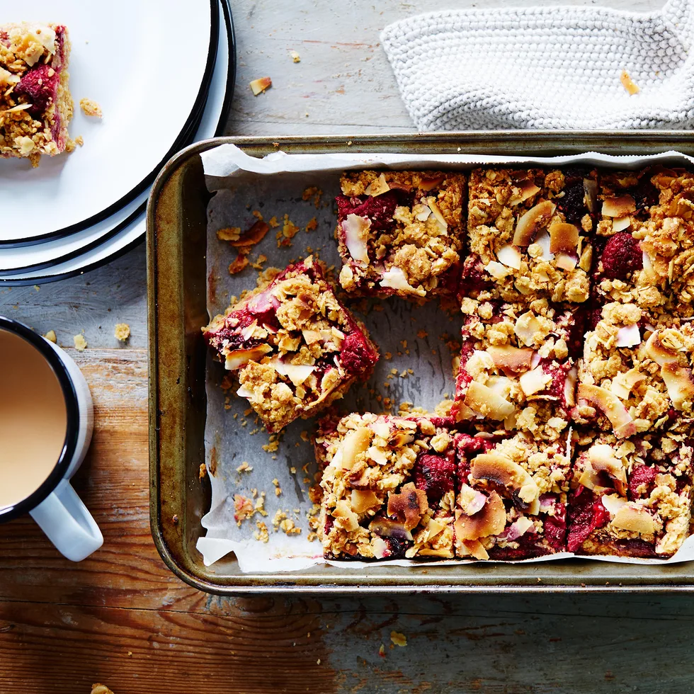 oat slice recipe in a tray with a cup of tea beside it