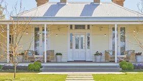 Country Australian home facade with wrap around verandah and corrugated iron roof. Designed by Scott Cam of The Block.