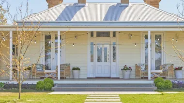 Country Australian home facade with wrap around verandah and corrugated iron roof. Designed by Scott Cam of The Block.