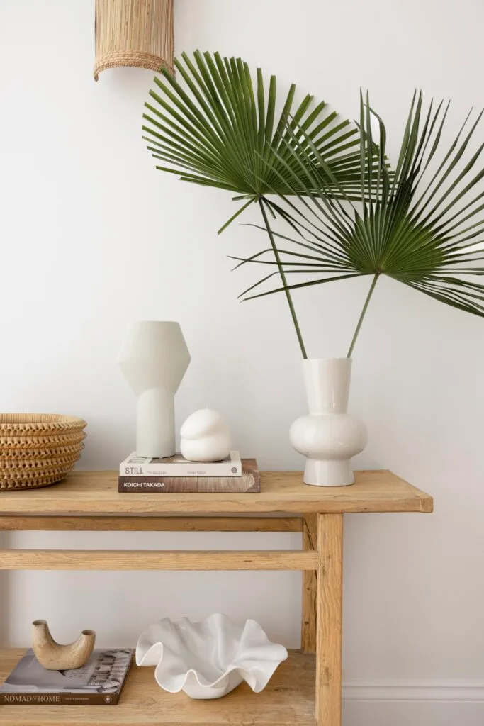 A timber side table with ceramic vases.