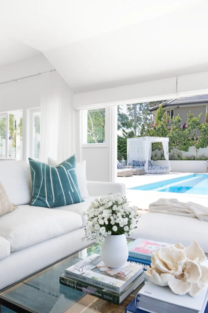 The living area with open doors to the pool and cabana.