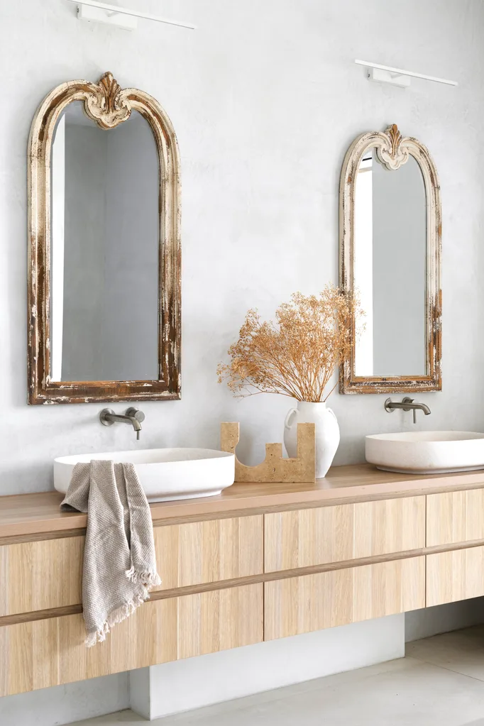 The main ensuite with vintage style mirrors and a timber vanity.