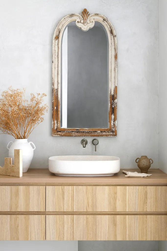 The ensuite vanity with a white ceramic vase.