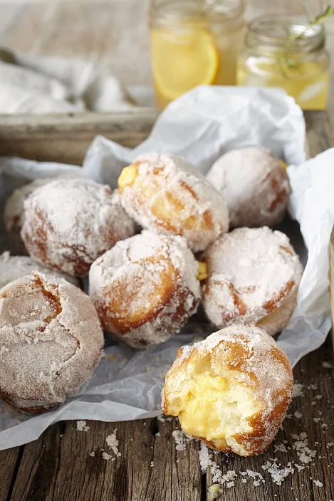 A serving of orange and custard-filled doughnuts.