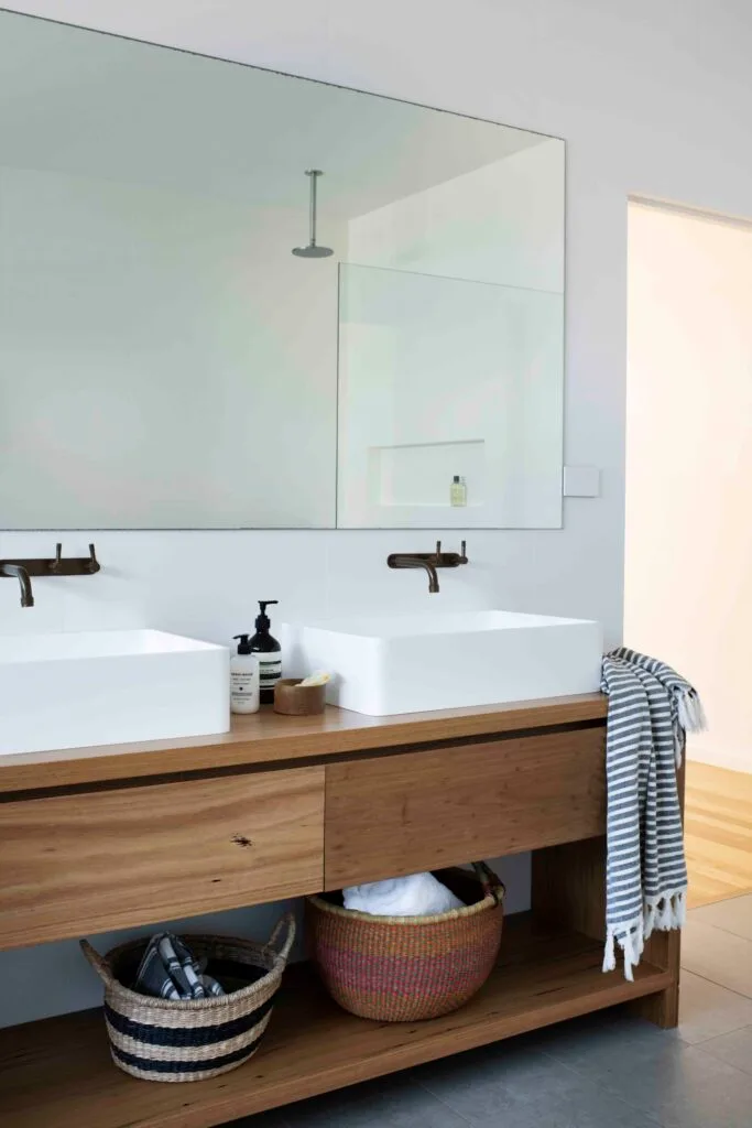 Bathroom with timber vanity and storage.