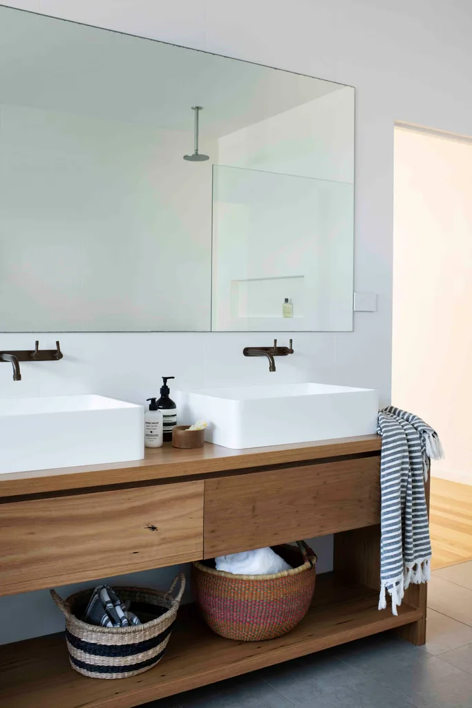 Bathroom with timber vanity and storage.