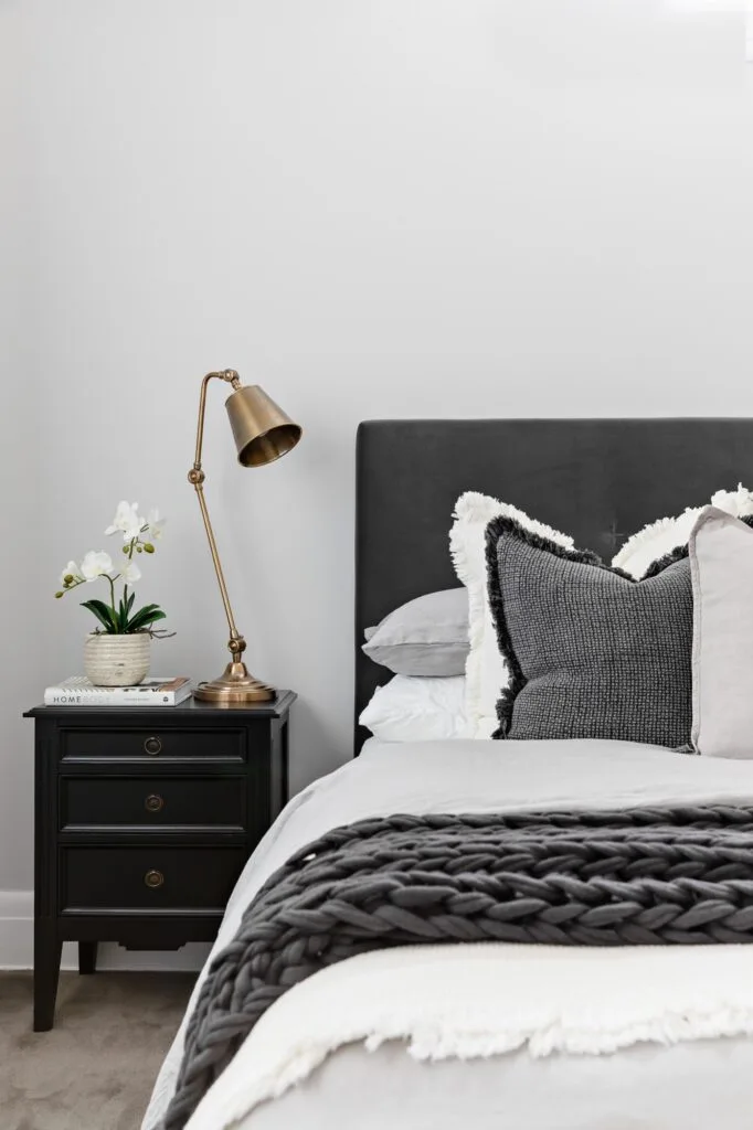 Bedroom with black and white furnishings.