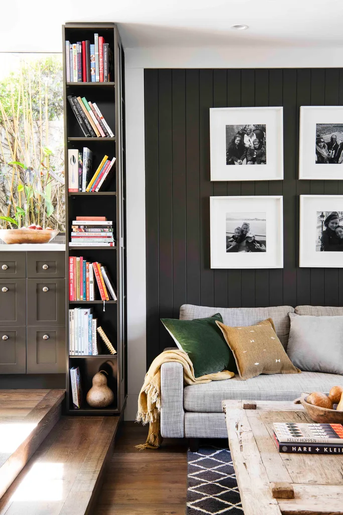 Living room with black vertical detailing and bookshelf.