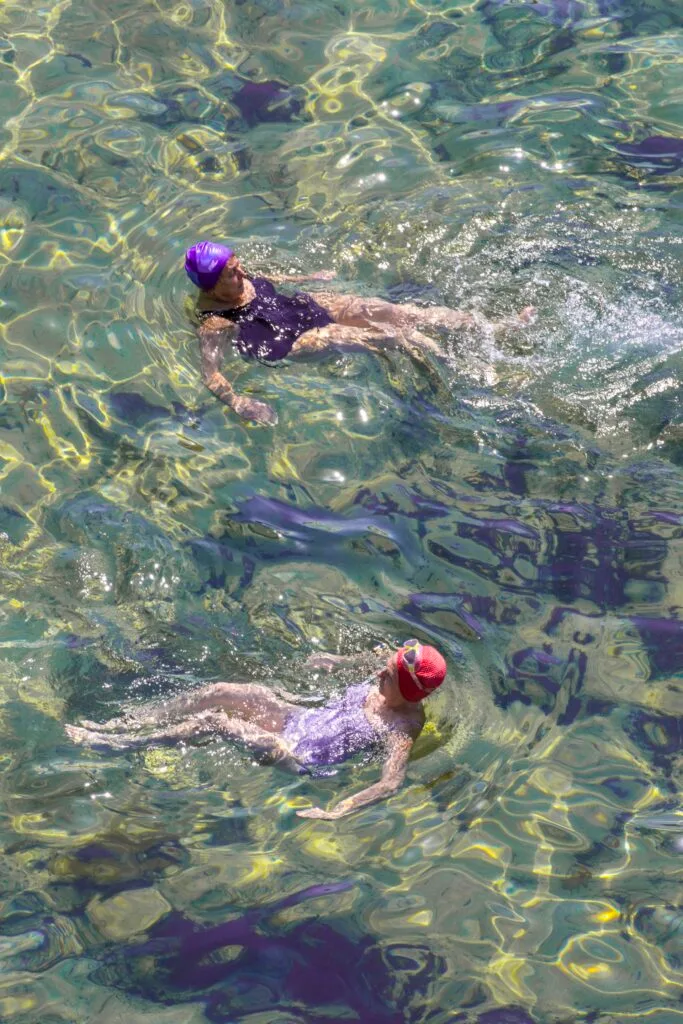 A photo of two swimmers in caps by Laura Reid.