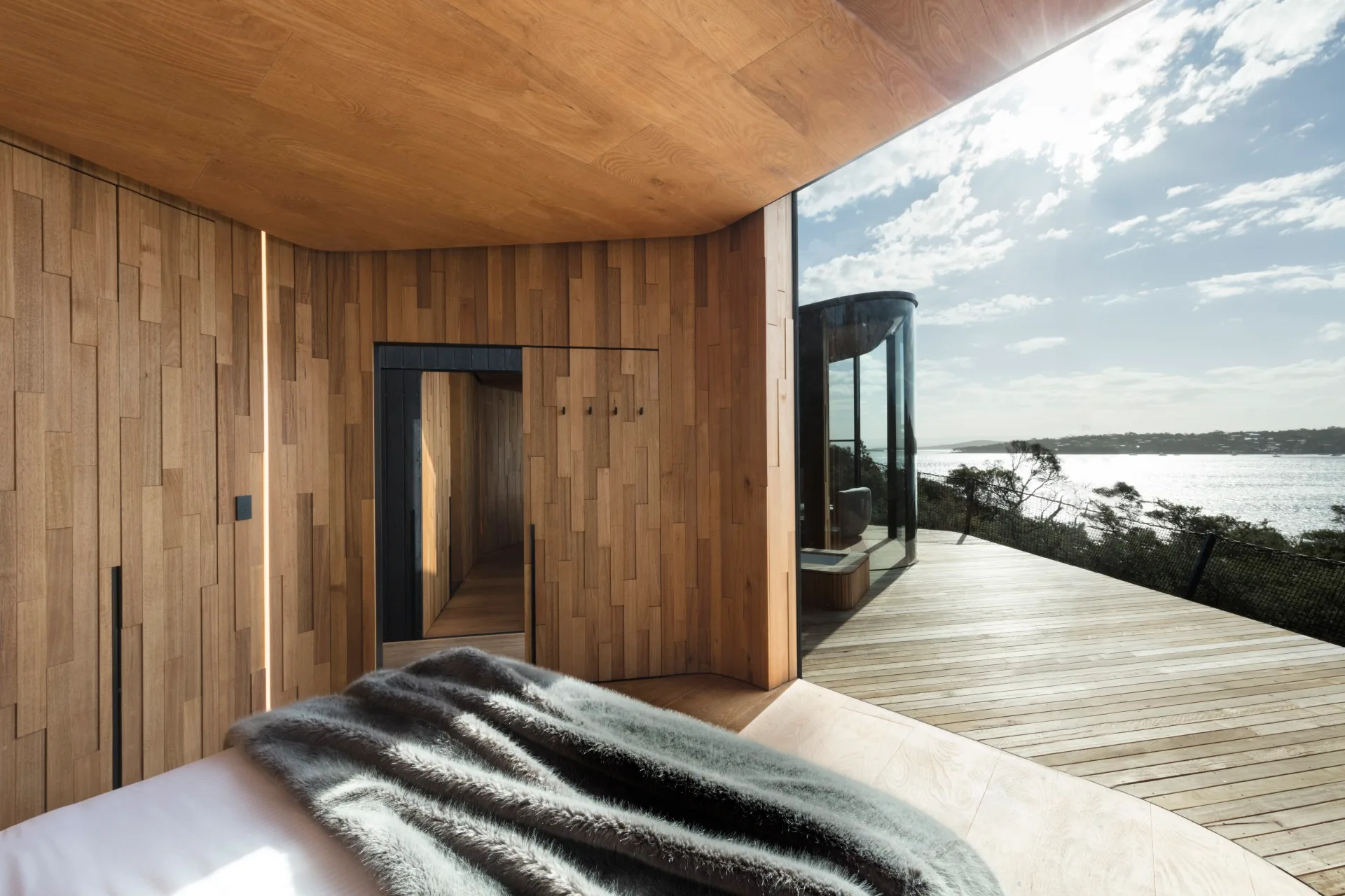 A rounded timber lodge overlooking the water in Freycinet, Tasmania.