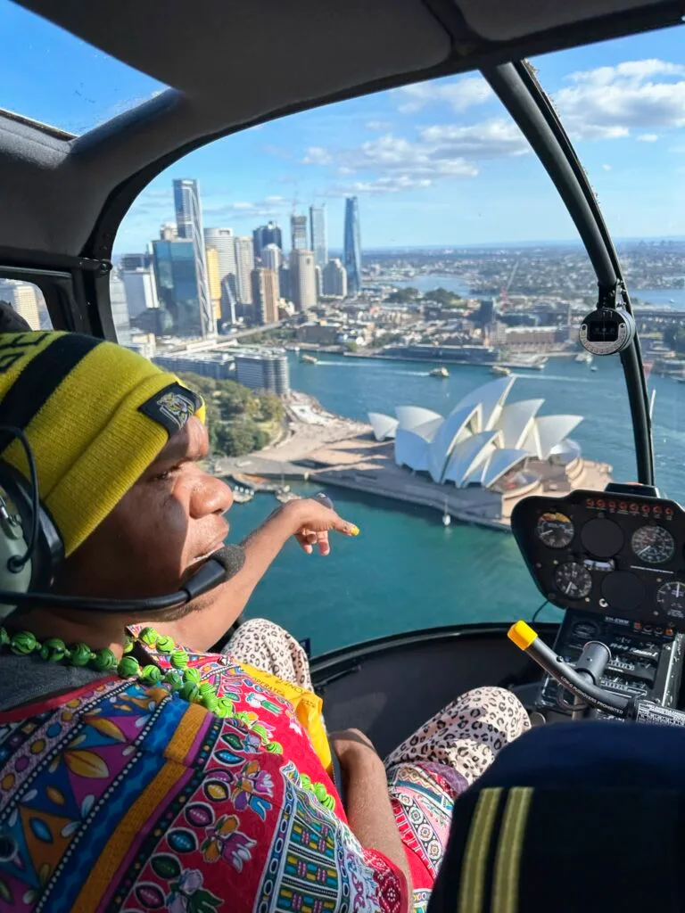 Australian Indigenous artist Karen Napaljarri Barnes sitting in a helicopter.