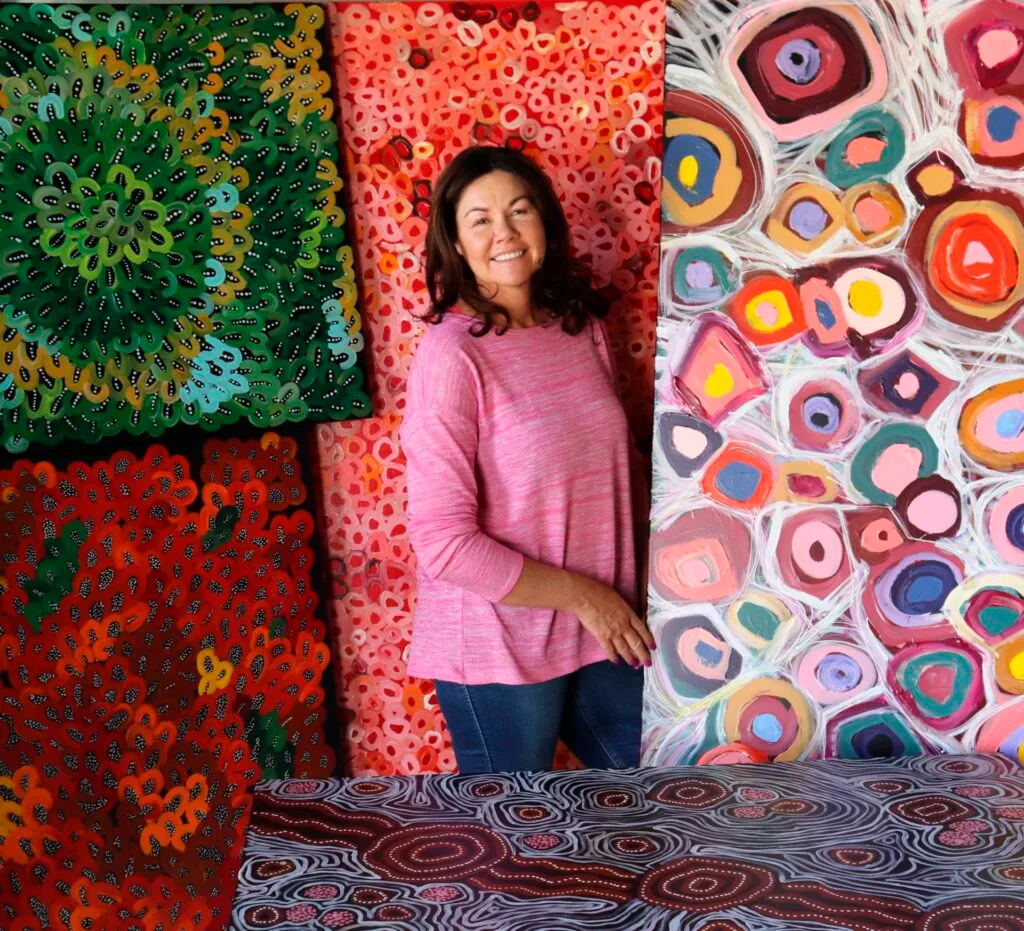 Australian Indigenous artist Maria Watson-Trudgett with her abstract paintings