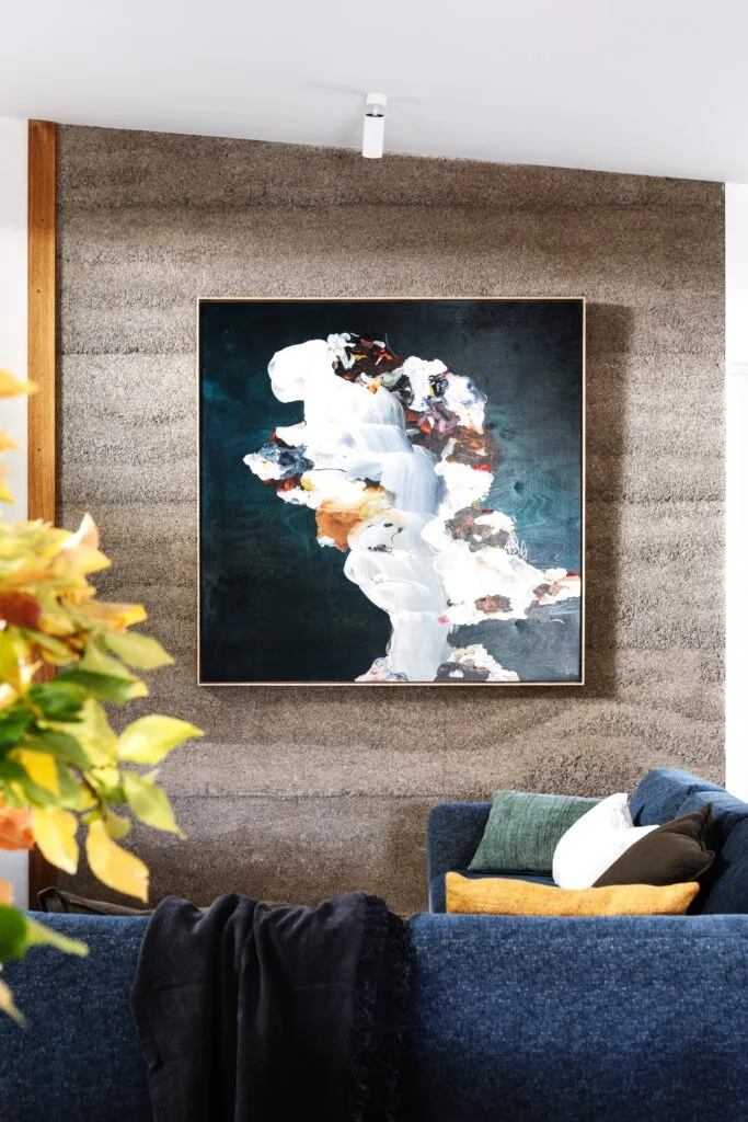 A dramatic abstract artwork in the living area.