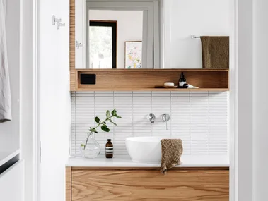 A white and timber ensuite with white finger tiles.