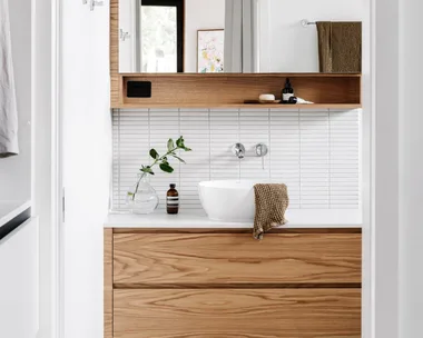 A white and timber ensuite with white finger tiles.