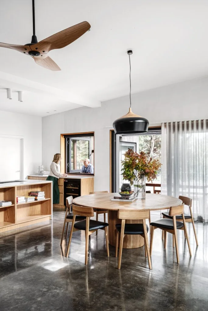 Japandi style kitchen and dining room with a timber dining table.