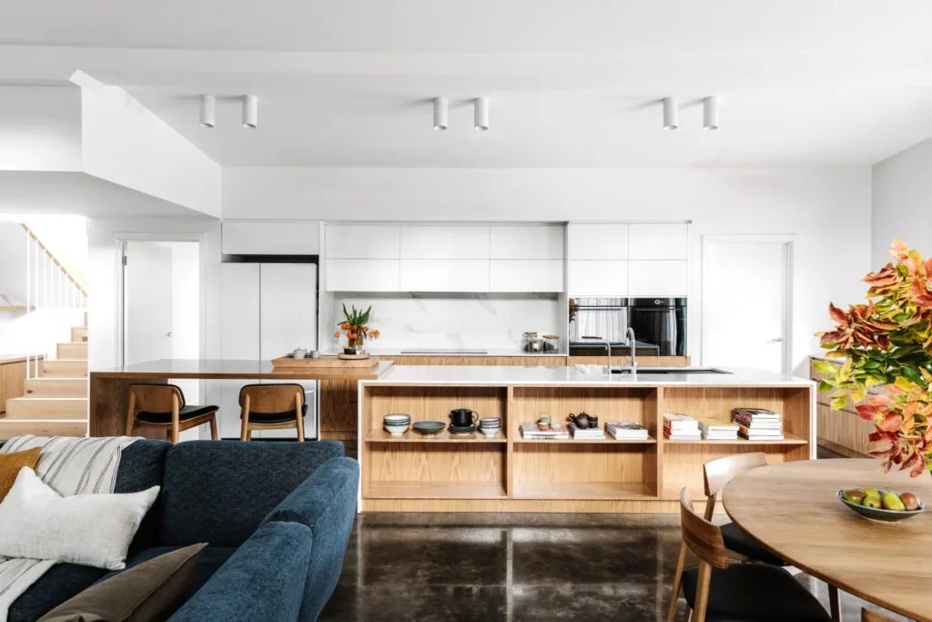 A Japandi style kitchen with open timber shelving and a raised white ceiling.