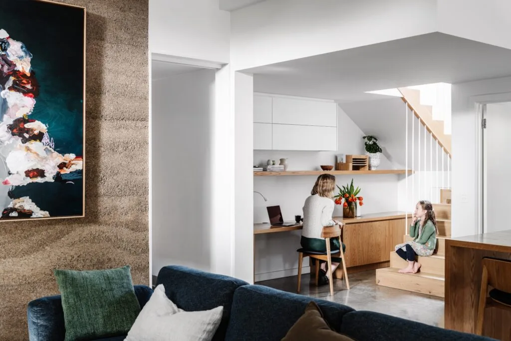 A minimalist timber study nook beneath the staircase.