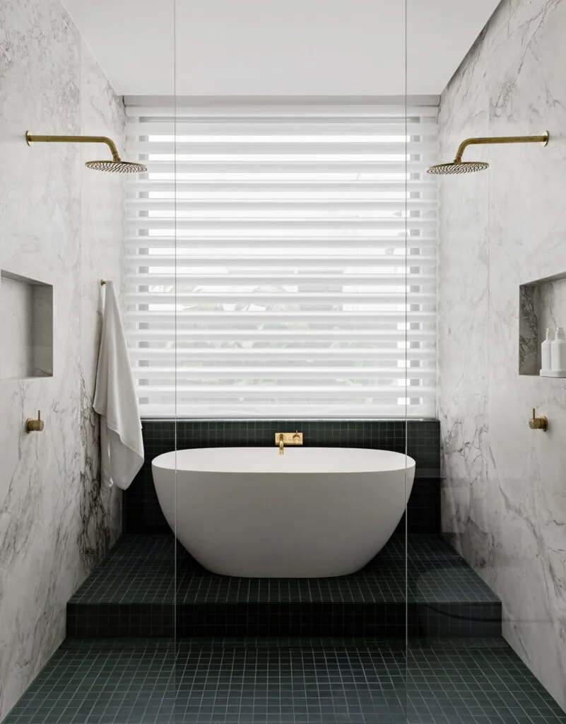 Contemporary bathroom with marble and twin showers.