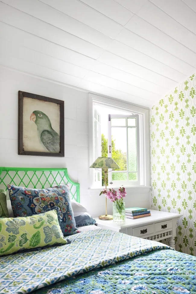 A bright cottage-style guest bedroom with a vintage quilt.