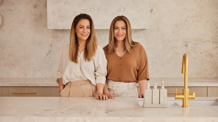 Alisa and Lysandra Design Duo in a luxurious looking beige marble kitchen