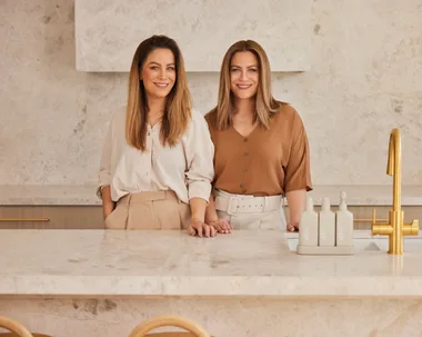 Alisa and Lysandra Design Duo in a luxurious looking beige marble kitchen