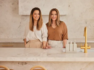 Alisa and Lysandra Design Duo in a luxurious looking beige marble kitchen