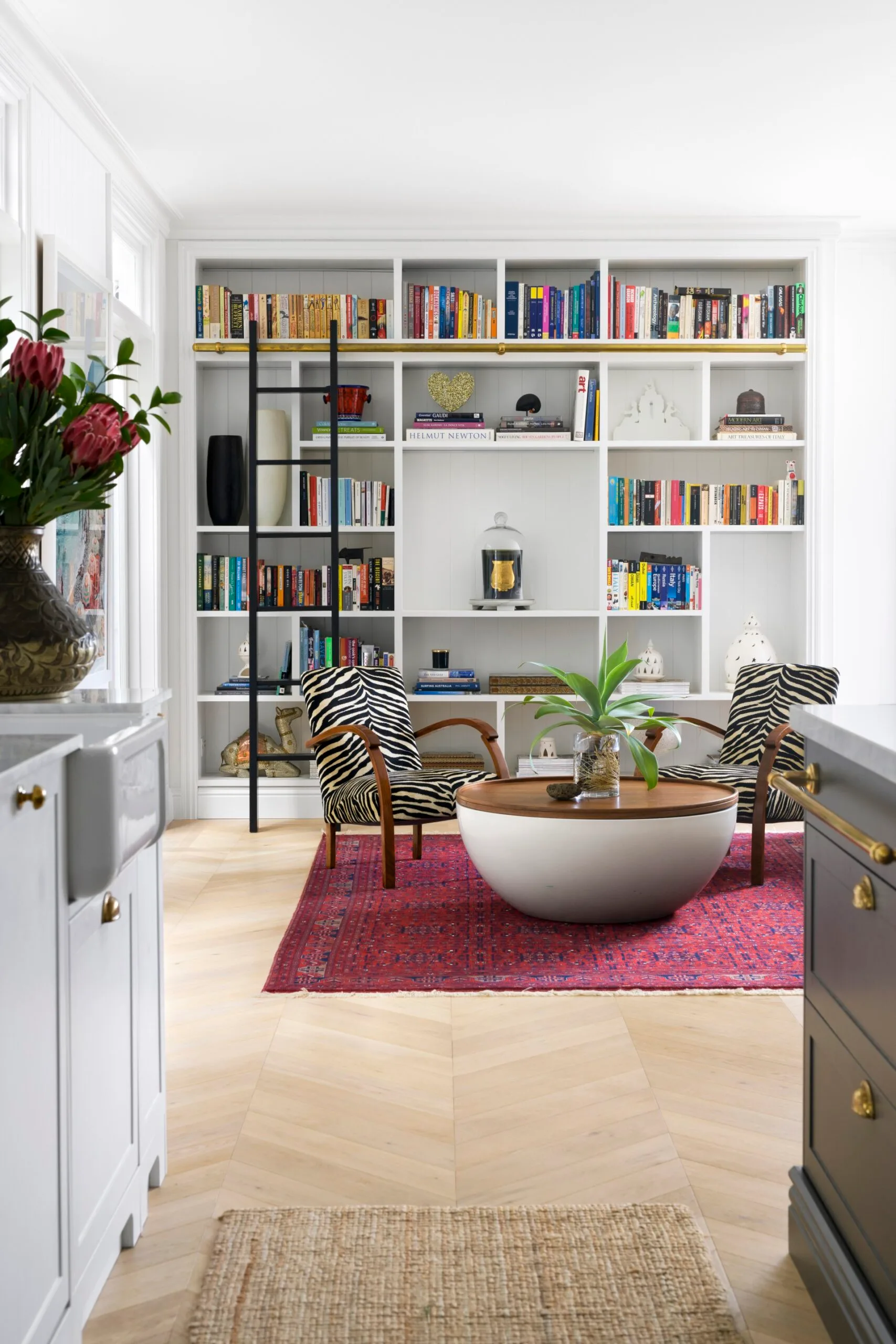 A book nook with zebra armchairs and a round table.