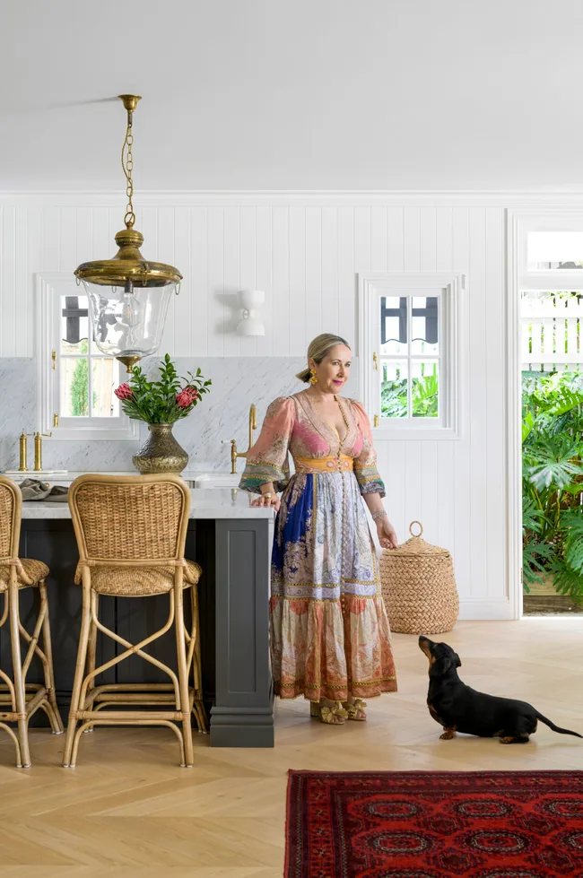 Interior designer Tori and a dachshund in the kitchen.