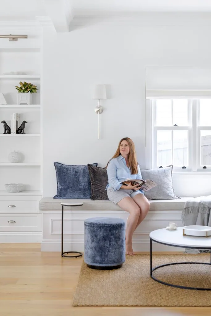 Owner Lorena sitting on a window seat in the living area.