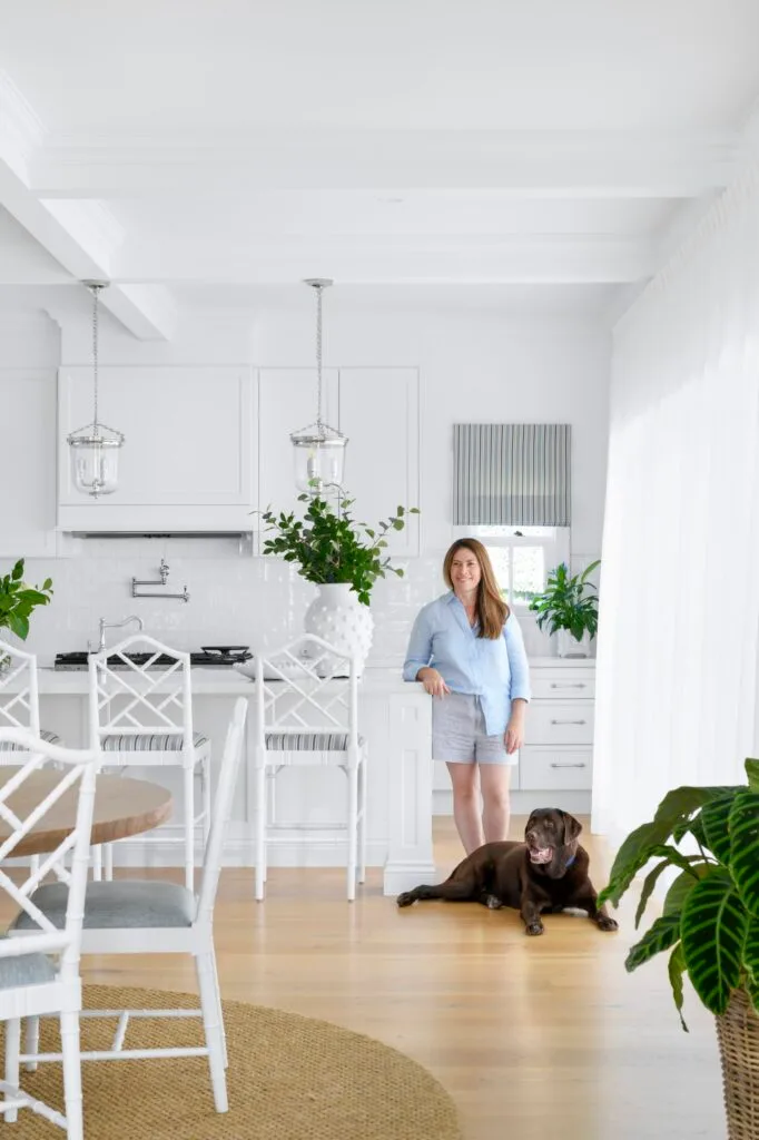 Owner Lorena with a chocolate Labrador in the kitchen.