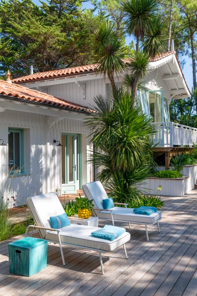 White sun loungers on a deck.