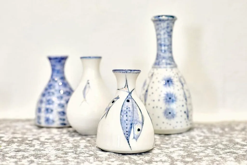 A collection of blue and white sea-themed ceramic vases.