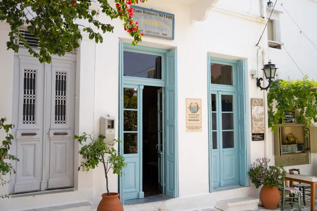 A Greek building with blue doors and a white facade.