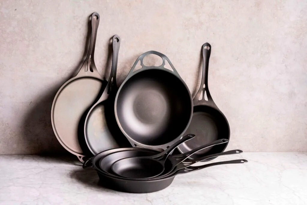 A collection of wrought iron cookware.