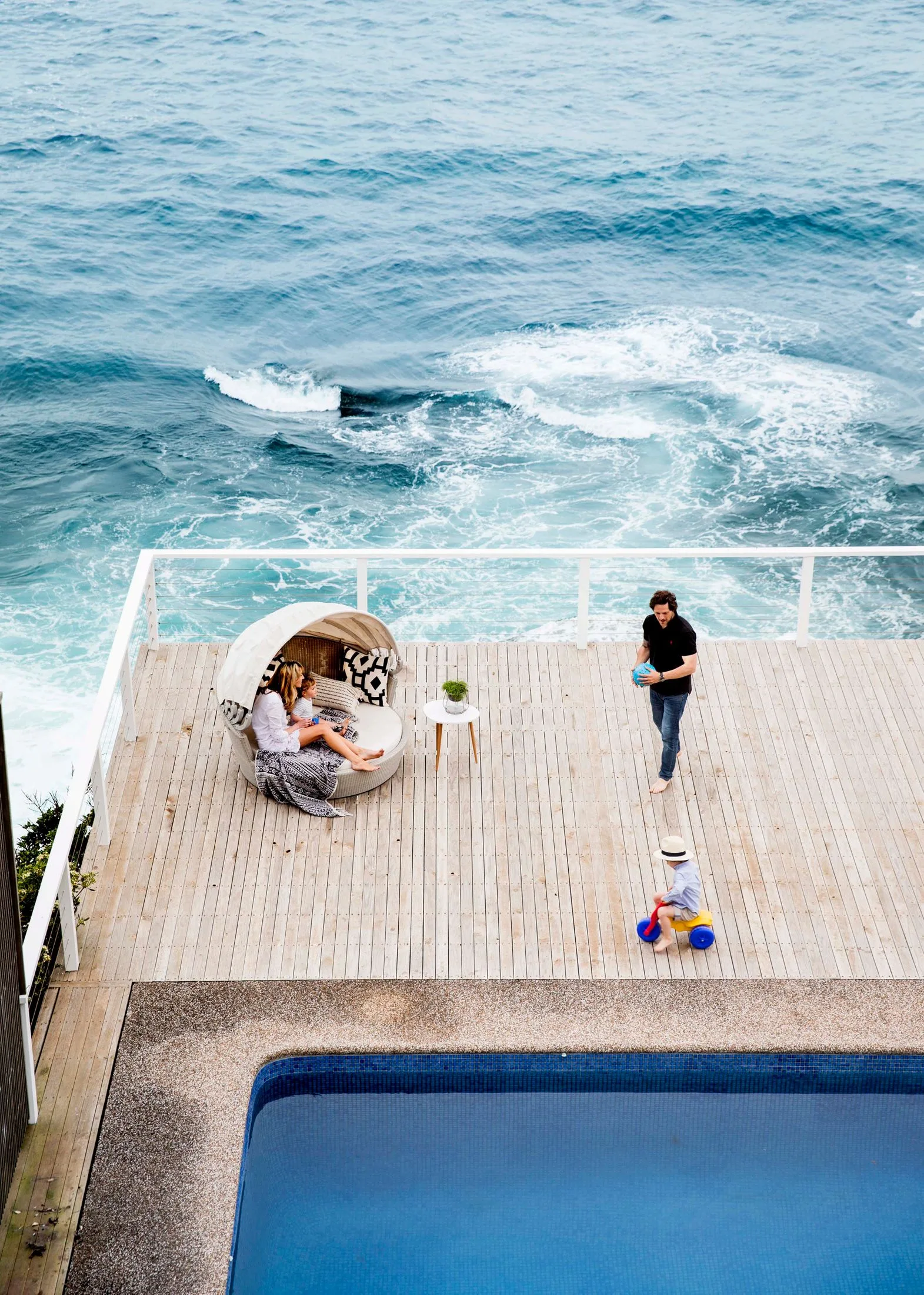 Juliet Love and Charlie Albone on the deck of their Sydney home with their two sons.