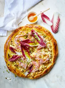 A mozzarella, pistachio and mortadella pizza.