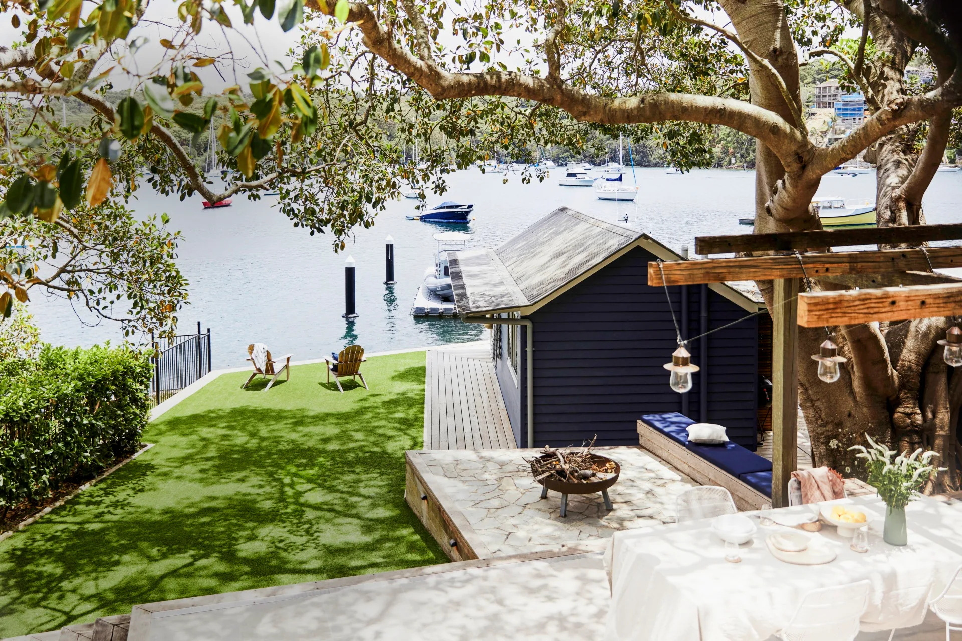 A blue garden boatshed on the bay in Sydney's North Shore.
