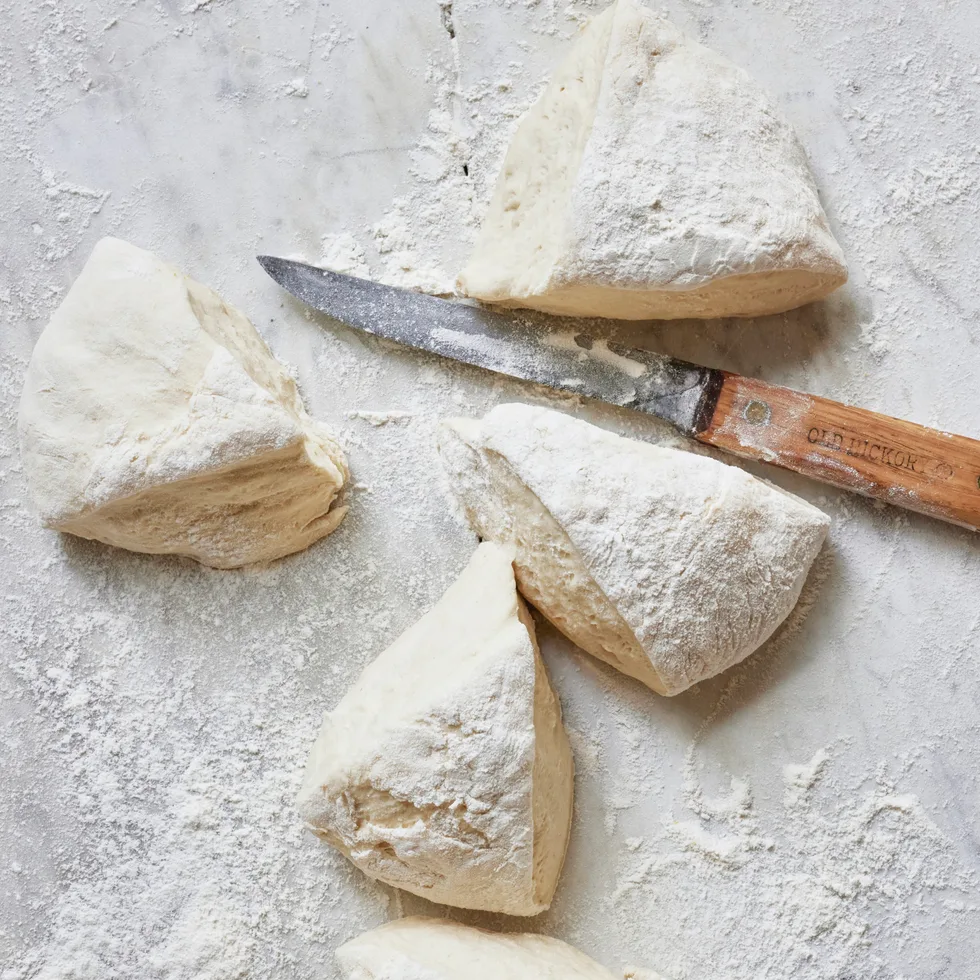 Cut pieces of pizza dough.