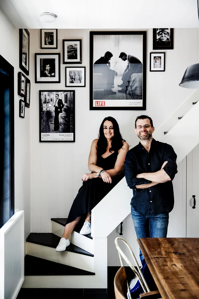 Man and woman stand on the stairs of a Sydney home decorated with vintage and antique finds.