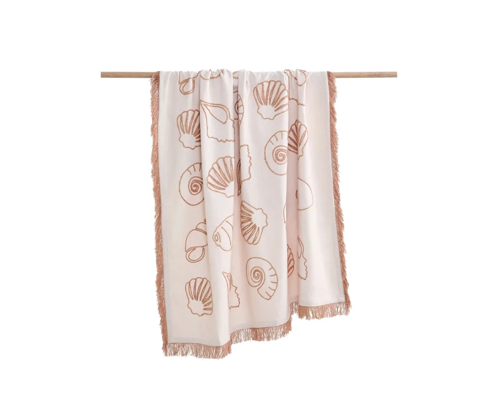 An embroidered seashell throw.
