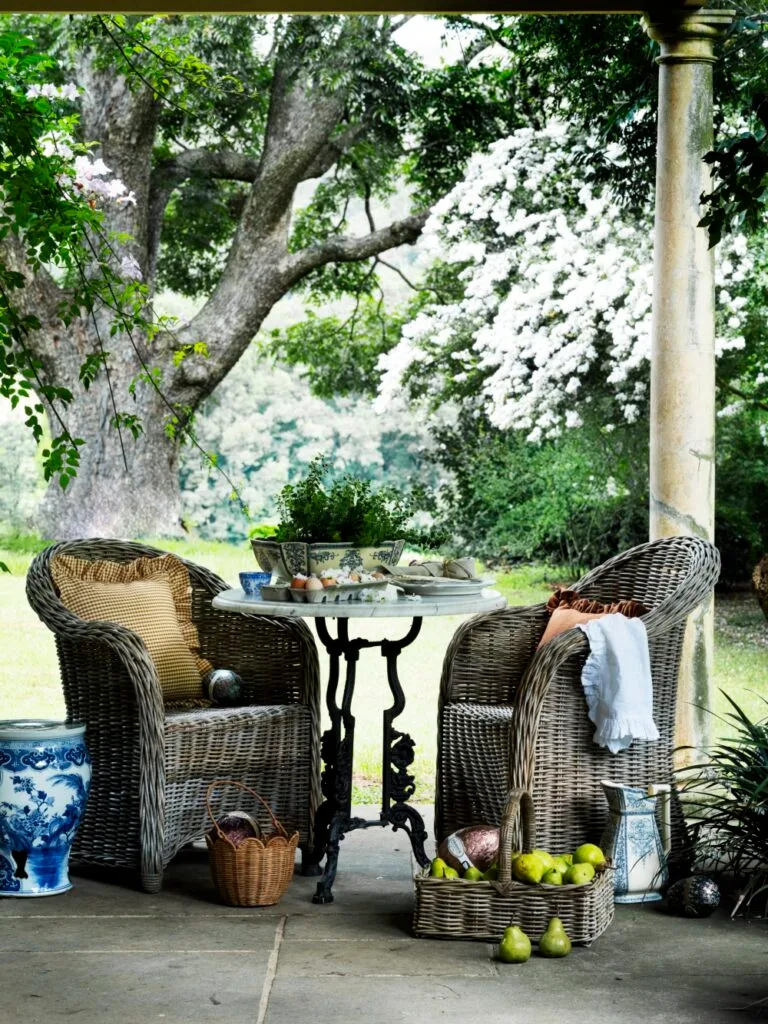 Easter Egg Hunt Wicker Chairs In Garden With Fruit Basket