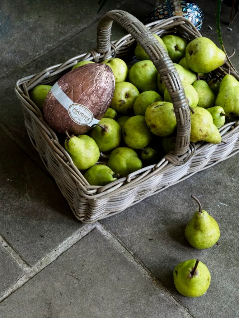 Easter Egg Hunt Basket With Pears and Easter Eggs