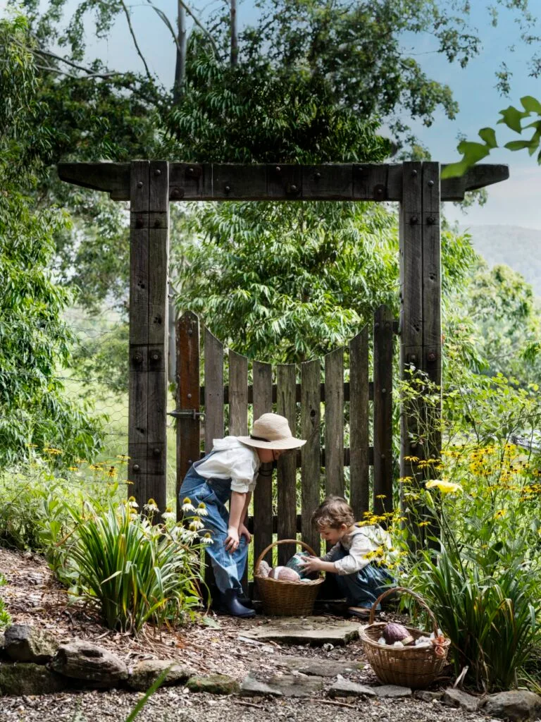 Easter Egg Hunt Children At Picket Fence