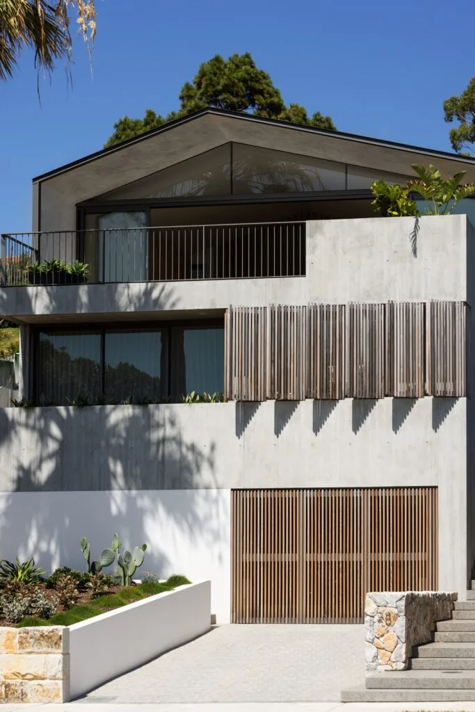 A modern two-storey home with timber slatted window covers.